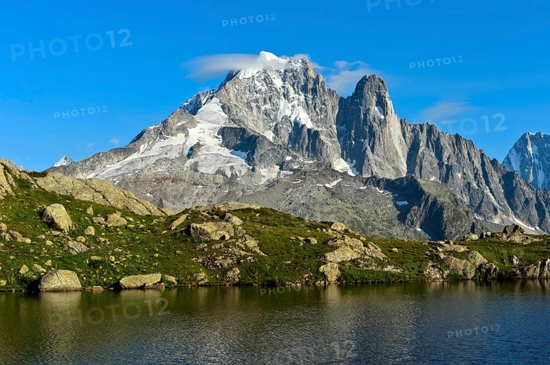 At the Lacs des Chéserys mountain lake in the Aiguilles Rouges nature reserve, view of the Aiguille Verte and Aiguille du Dru peaks, Chamonix, Haute Savoie, France, Europe