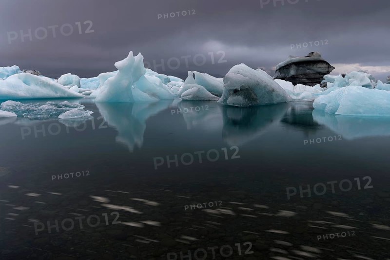 Icebergs under dark clouds, dramatic and threatening, long exposure, glacier lagoon Jökulsárlón or Jökulsarlon, South Iceland, Iceland, Europe