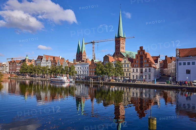 River Trave with quay wall, historical buildings, church towers of St. Marien and St. Petri, reflection on the water surface, Hanseatic city of Lübeck, independent city, Schleswig-Holstein, Germany, Europe