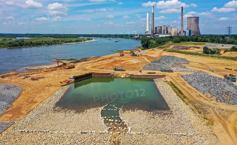Dinslaken, Voerde, North Rhine-Westphalia, Germany, Emscher estuary into the Rhine. Construction site of the new Emscher estuary in front of the decommissioned STEAG coal-fired power station in Voerde. The mouth of the Emscher into the Rhine is being moved almost 500 metres north from Dinslaken to Voerde. Fish will then be able to swim barrier-free up the new Emscher from the Rhine through a newly created floodplain area. Following the construction of a parallel sewer, the Emscher has been completely free of sewage since January 2022. The river was previously an open, above-ground combined sewer with rainwater and wastewater, Europe