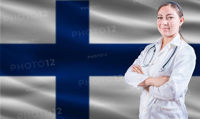 Female doctor on Finland flag. Doctor with crossed arms on Finland flag. Finland Health and Care concept