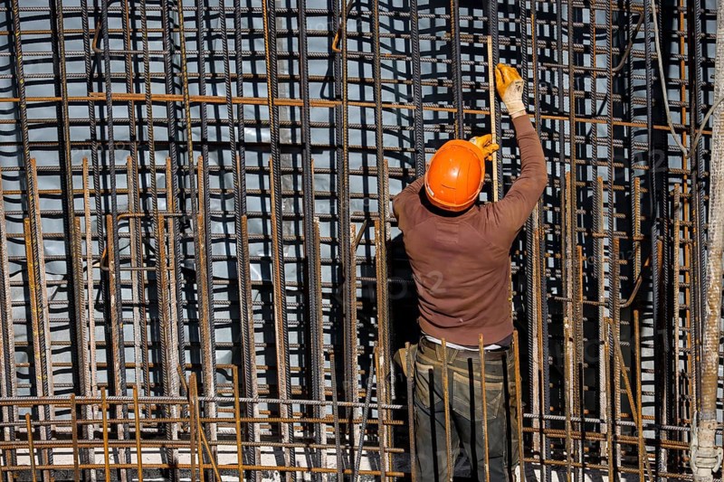 Essen, North Rhine-Westphalia, Germany, construction industry, construction workers working on a building site. Iron binder is a job title for construction workers who bind reinforcing mesh for the reinforcement of concrete parts. The meshes are prepared together with the formwork builder to form moulds, which are then filled with fresh concrete, Europe