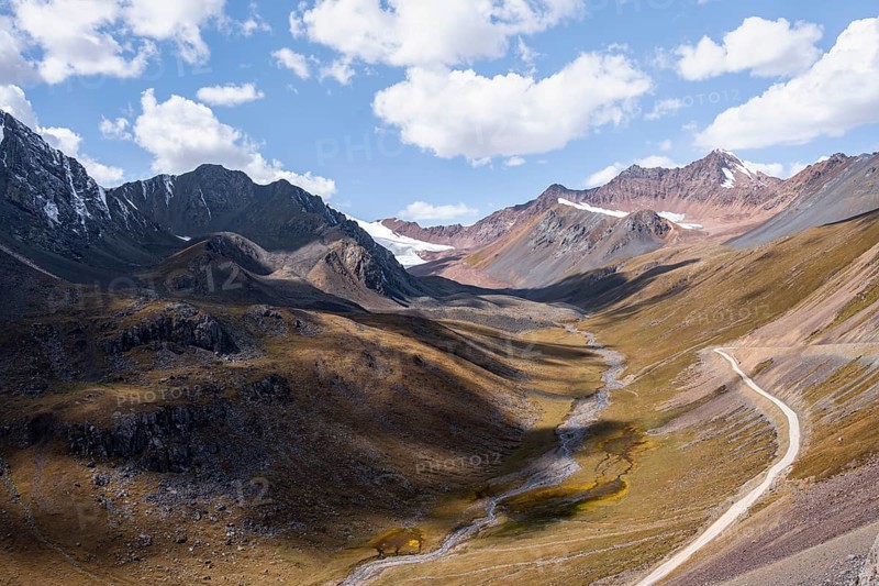 Mountain river in a valley, picturesque mountain landscape with white mountain peaks, Tian Shan Mountains, Issyk-Kul, Kyrgyzstan, Asia
