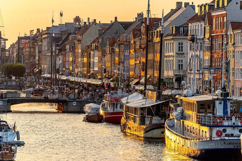 Colourful houses, restaurants and historic ships on the Nyhavn canal and harbour, Copenhagen, Denmark, Europe