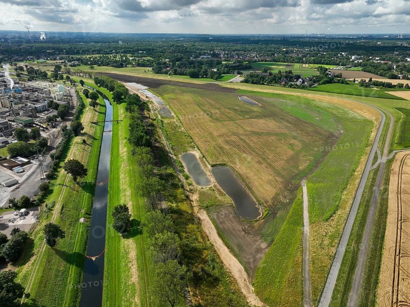 Oberhausen, North Rhine-Westphalia, Germany, renaturalisation of the Emscher in the Holtener Bruch. A new floodplain landscape for flood protection and biodiversity is being created here. Left: OQ Chemicals plant Ruhrchemie. The Emscher, which is currently straightened, is given curves again and can meander through its new floodplain. The ecological reorganisation of the Emscher system consists of the construction of a central wastewater treatment system in the Ruhr area, the construction of sewers and the renaturation of the Emscher and its tributaries. Following the construction of a parallel sewer, the Emscher has been completely free of sewage since January 2022. The river was previously an open, above-ground combined sewer with rainwater and wastewater, Europe