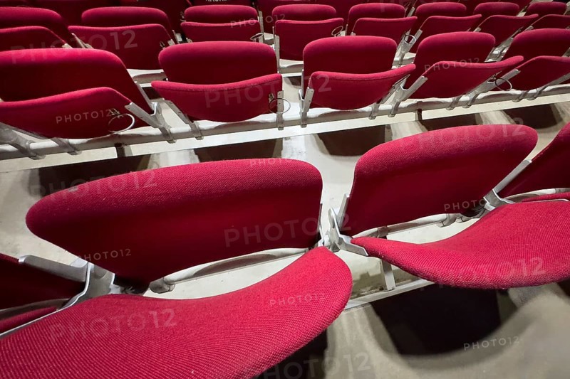 Empty folded-up seats Folding chairs with backrests in rows of seats mounted next to each other Seating in front of event Event in multi-purpose hall, Germany, Europe