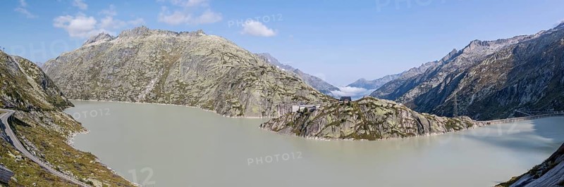 Grimselsee or Lake Grimsel with the historical Hotel Grimsel Hospiz near the Grimsel Pass in the Canton of Berne, Switzerland, Europe