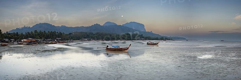 Before sunrise, longtail boats lie at low tide in the harbour at Sivalai Beach, Koh Mook Island, Satun Province, Southern Thailand, Thailand, Asia