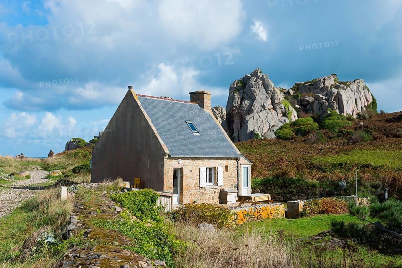 Lonely house in a rural landscape with rocks under a cloudy sky, Plage de Pors Scaff, Plougrescant, Côtes-d'Armor, English Channel, Brittany, France, Europe