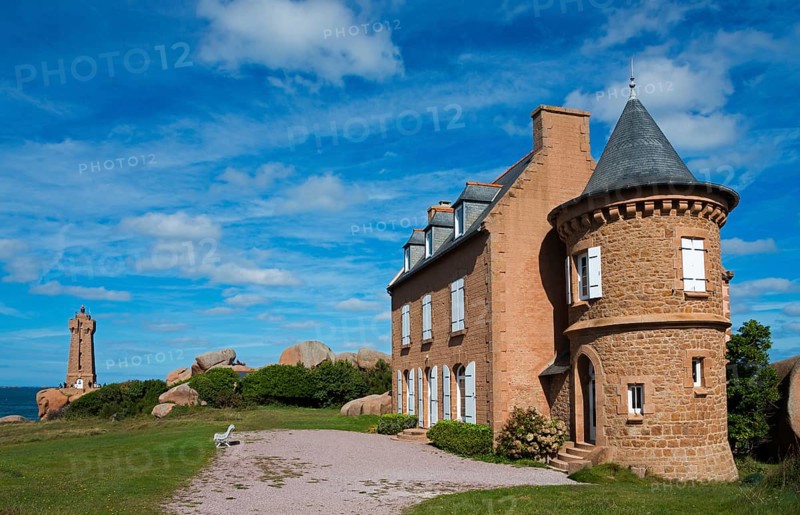 Historic castle with red stone tower under blue sky and clouds, Phare de Men Ruz and Maison Gustave Eiffel, Ploumanac'h, Ploumanach, Pointe de Squewel, Perros-Guirec, pink granite coast, Côte de Granit Rose, Brittany, France, Europe