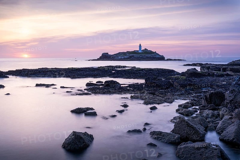 Godrevy Lighthouse, the lighthouse of Godrevy on Godrevy Island. In the evening at sunset. Long exposure. Cornwall, England, Great Britain