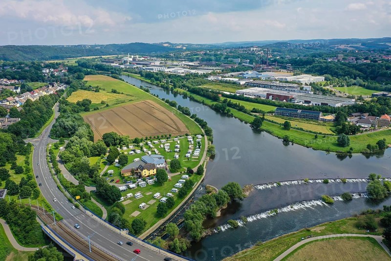 Hattingen, North Rhine-Westphalia, Germany - Cityscape at the Ruhr, Ruhrpromenade, in front a camping site at the Ruhr weir and the bridge Bochumer Straße L651, in the back the LWL-Industriemuseum Henrichshütte Hattingen