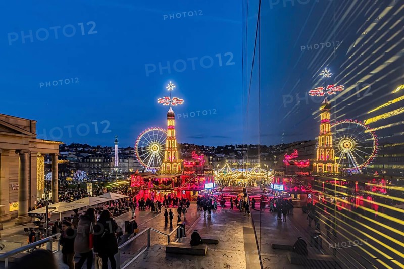 Stuttgart Christmas market at the blue hour. Christmas pyramid on Schlossplatz in front of the New Palace with Ferris wheel. The traditional event attracts more than three and a half million people to the city centre during the Christmas season. Stuttgart, Baden-Württemberg, Germany, Europe