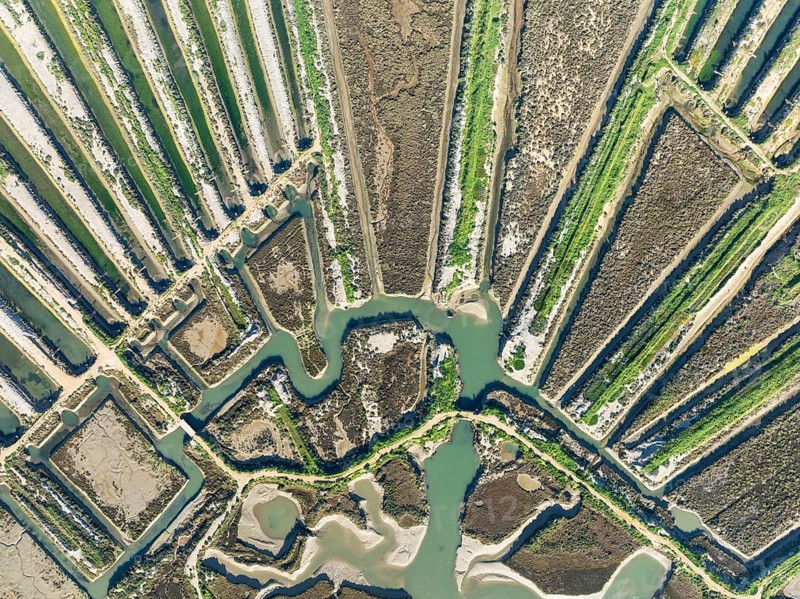 Saline ponds at the salt works of Isla Cristina. Aerial view. Drone shot. Huelva province, Andalusia, Spain, Europe