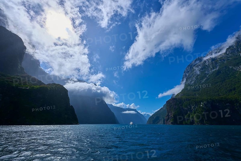 Dramatic scenery with water and cloudy sky between rock faces, summer, Milford Sound, Te Anau, Fiordland National Park, South Island, New Zealand, Oceania