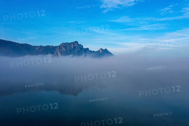 Drone shot, morning fog at Mondsee in autumn with Drachenwand, Salzkammergut, Upper Austria, Austria, Europe