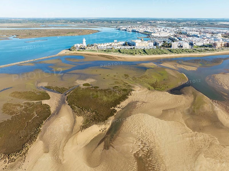 The town of Isla Cristina adjacent to the Lago de la Gaviota (lake of the seagull) at low tide. Aerial view. Drone shot. Huelva province, Andalusia, Spain, Europe