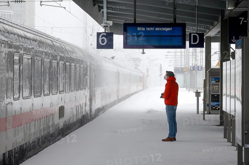 Essen, North Rhine-Westphalia, Germany - Onset of winter in the Ruhr area, Essen railway station, many trains are delayed or cancelled due to ice and snow, passenger waiting for train