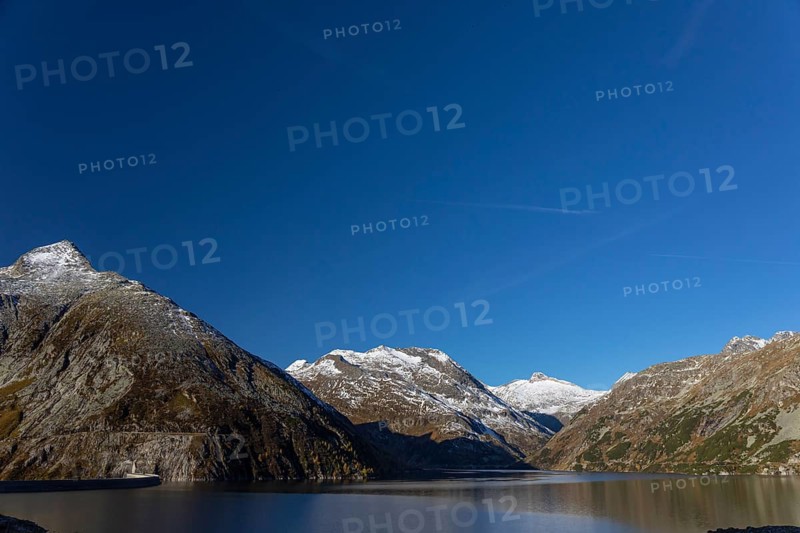 Kölnbrein reservoir and the Oberlecherspitzen mountain on a bright sunny morning. Seen from the Malta Hochalm road. Carithia, Austria, Europe