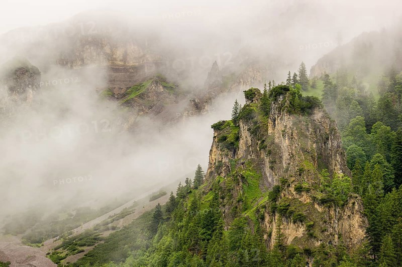 Wisps of mist cover the Karwendel mountains in the Großer Ahornboden nature reserve, Eng Valley, Tyrol, Austria, Europe