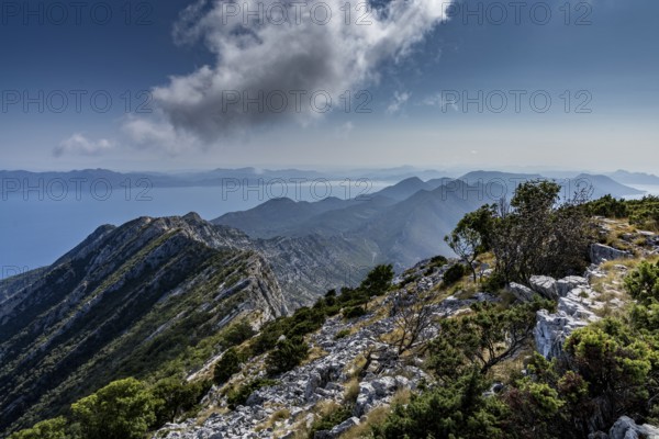 Expansive mountain landscape with panoramic views of the sea and clouds in the sky, Peljesac, Croatia, Europe