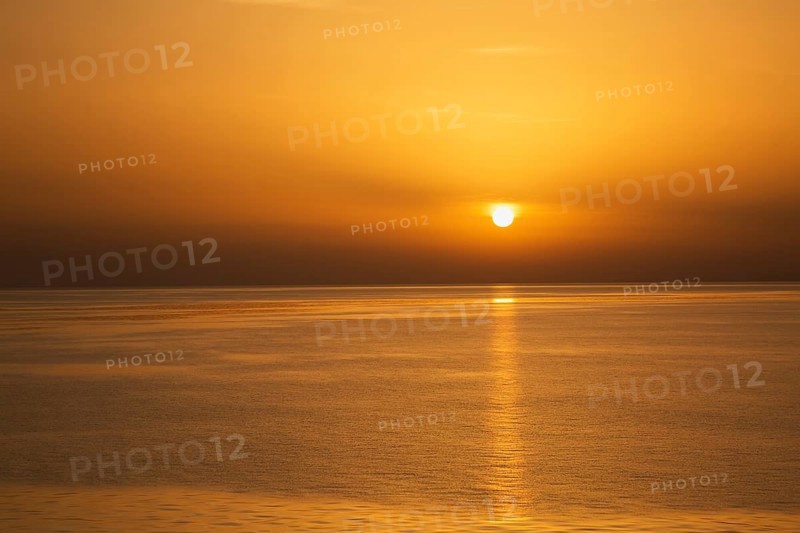 Setting golden sun over Adriatic sea taken from the top deck of a cruise ship in late summer, near Zadar, Croatia, Europe