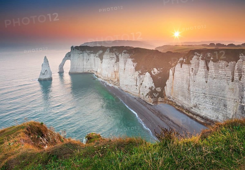 The coast of Etretat (Étretat) at sunrise, cliffs with Porte d'Aval and Aiguille rock needle, Normandy, France, Europe
