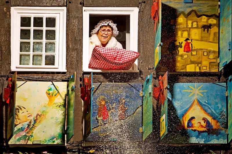 Mrs Holle shakes out her pillow at the big Advent calendar at the Old Town Hall, Nostalgic Christmas Market, Hattingen, Germany, Europe