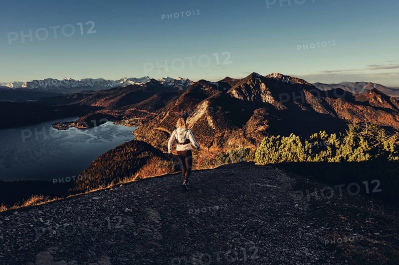 Trail running in autumn on the Jochberg on Lake Walchensee against the wonderful backdrop of the Alps, Bavaria, Germany, Europe