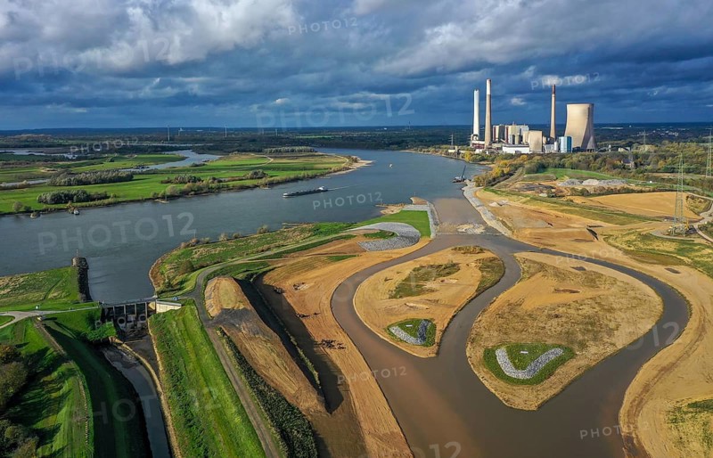 Dinslaken, Voerde, North Rhine-Westphalia, Germany, Inauguration of the new Emscher estuary into the Rhine. The decommissioned STEAG Voerde coal-fired power station is in the background. The mouth of the Emscher into the Rhine has been moved almost 500 metres north from Dinslaken to Voerde. Fish can now swim barrier-free up the new Emscher from the Rhine through a newly created floodplain area. Following the construction of a parallel sewer, the Emscher has been completely free of sewage since January 2022. The river was previously an open, above-ground combined sewer with rainwater and wastewater, Europe