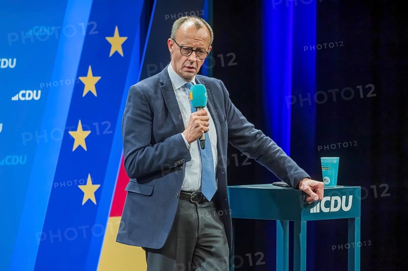 Election event of the CDU party for the Bundestag elections with top candidate Friedrich Merz. Portrait in front of the German flag and the flag of the European Union. Singen am Hohentwiehl. Baden-Württemberg, Germany, Europe