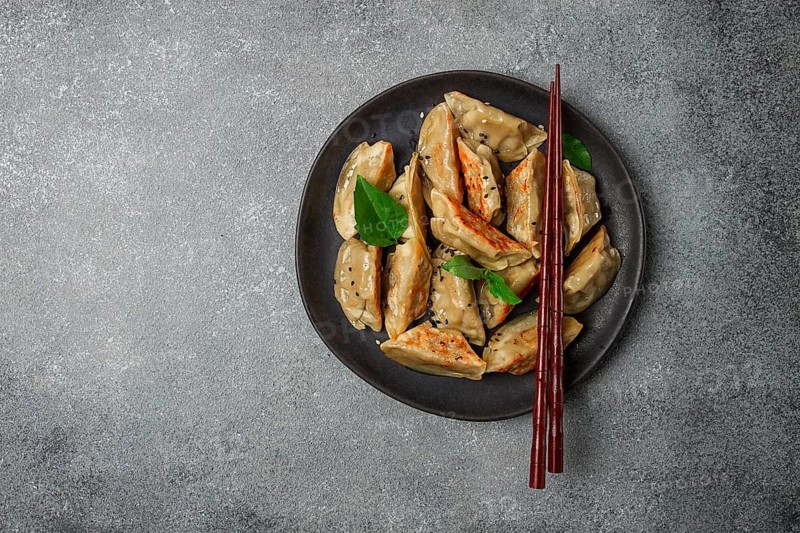 Japanese fried dumplings, gyoza, sesame seeds, top view, no people