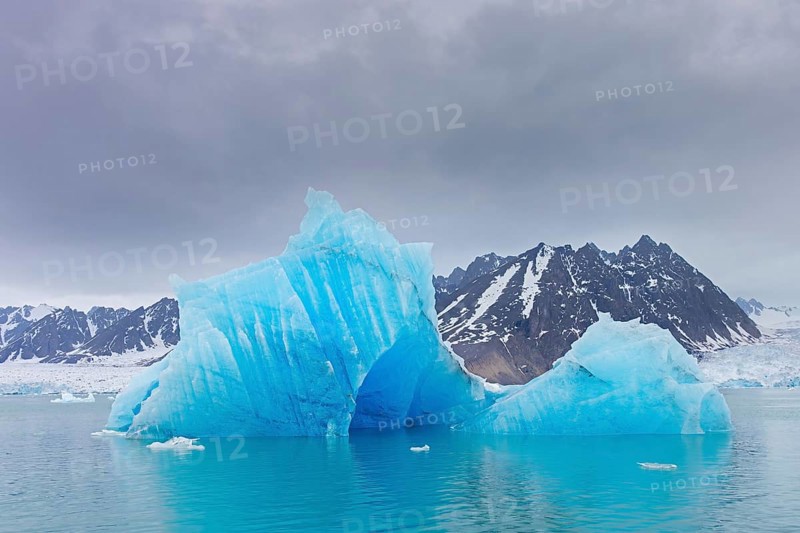 Iceberg, ice floe from calving Monacobreen glacier floating in the Liefdefjorden, fjord in Haakon VII Land, Spitsbergen, Svalbard