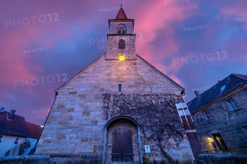 St Bartholomew's Church with poinsettia at dusk, Eschenau, Middle Franconia, Bavaria, Germany, Europe