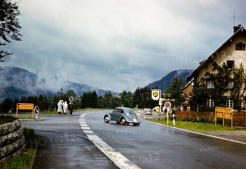Volkswagen VW Beetle turning off the main road towards Hinterzarten, Baden-Württemberg, Germany July 1959 Members of the Bromley Roller Club discussing on a corner