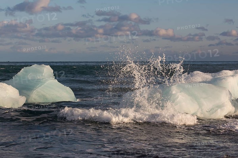 Little icebergs and crushed ice on the black beach at Joekulsarlon glacial lake