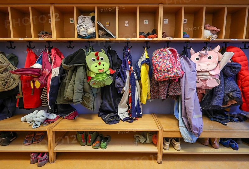 Germany - Symbolic image KITA. Children's coats, jackets and unicorn rucksacks hang on a coat rack in a kindergarten