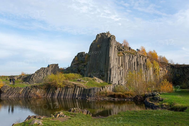 Mighty basalt formations rise under a blue sky, surrounded by autumnal greenery, manor house rocks, Panska skala, basalt elevation, natural monument, Prachen, Parchen, Kamenicky Senov, Steinschönau, Czech Republic, Europe
