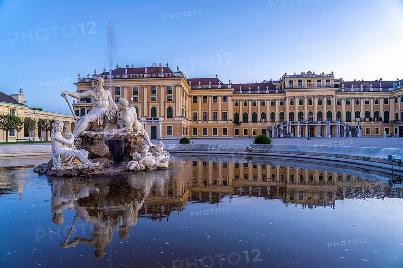Fountain in the courtyard of honour at Schönbrunn Palace at dusk, UNESCO World Heritage Site in Vienna, Austria, Europe