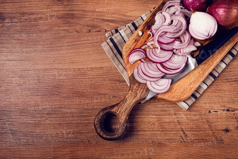 Sliced red onion, on a chopping board, with a knife, Spanish onion, raw onion, close-up, top view