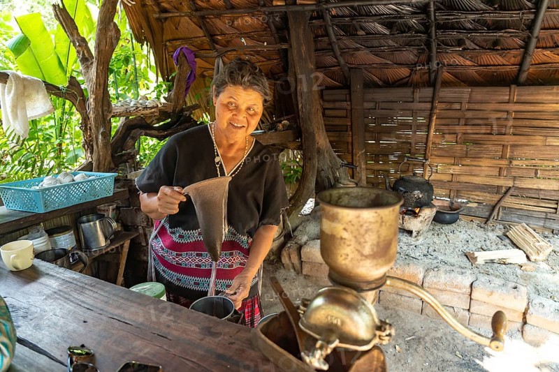 Karen woman in her kitchen in Mae Klang Luang village making coffee, Doi Inthanon National Park, Chiang Mai, Thailand, Asia