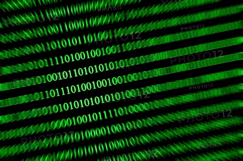 Slanted green binary code on a black background, conveys speed