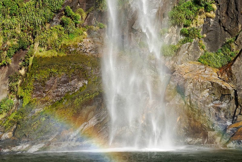 Rainbow over waterfall, Milford Sound, Fiordland National Park, South Island, Southland, New Zealand, Oceania