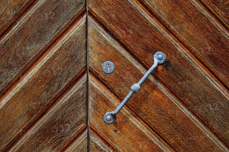Detail of a historic iron-framed wooden door in the outer wall of the Old Palace in Stuttgart, Baden-Württemberg, Germany, Europe