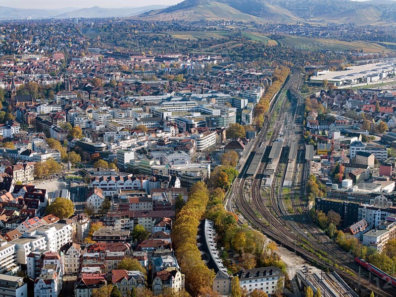 Stuttgart Bad Cannstatt with railway station, aerial view. Above it the Mercedes-Benz engine plant Cannstatt and vineyards. Stuttgart, Baden-Württemberg, Germany, Europe
