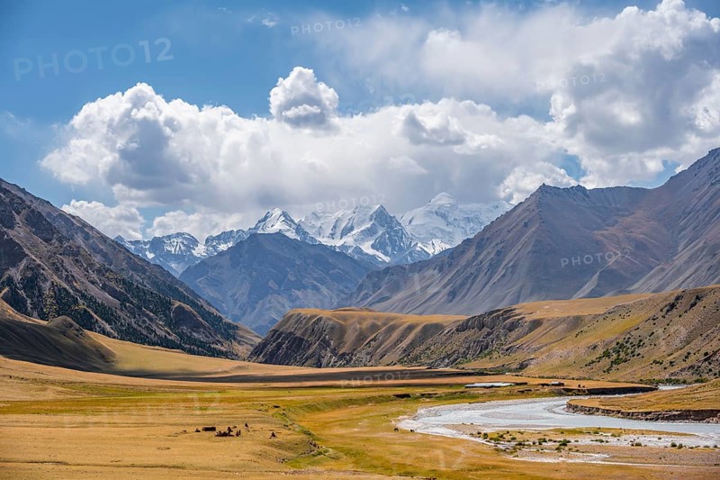 Mountain river in a valley, picturesque mountain landscape with white mountain peaks, Tian Shan Mountains, Issyk-Kul, Kyrgyzstan, Asia
