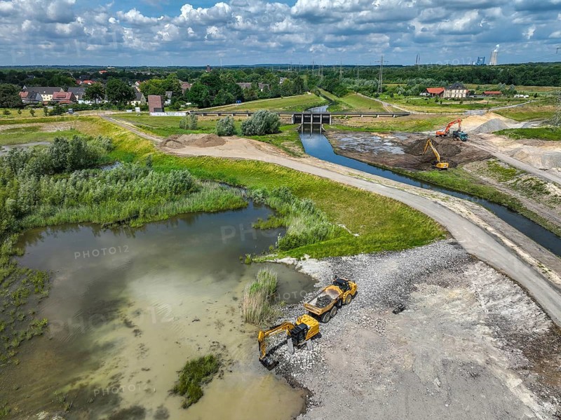 Dortmund / Castrop-Rauxel, North Rhine-Westphalia, Germany, renaturalisation of the Emscher, flood retention basin HRB Mengede. A new floodplain landscape for flood protection and biodiversity is being created at the Emscher-Auen farm. The Emscher, which is currently straightened, will be given curves again and can meander through its new floodplain. The Emscher has been completely free of sewage since 2022 following the construction of a parallel sewer. The river was previously an open, above-ground mixed water channel with rainwater and wastewater. The Uniper coal-fired power plant Datteln 4 in the background, Europe