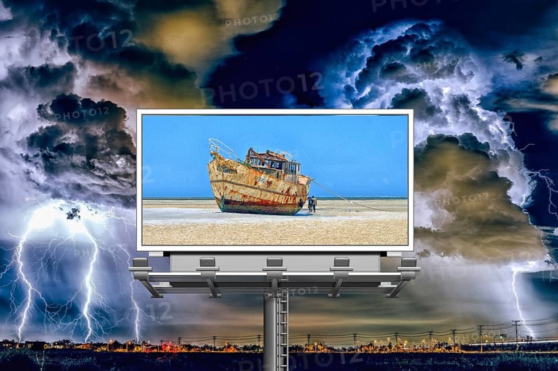 Symbolic image, storm over the city, billboard with ship on dry land, threat to paradise, water shortage, water emergency, global drought, climate crisis, climate change, climate change, famine, melting glaciers, warming, global warming, rising sea levels, Donald Trump president, US withdrawal from climate agreement