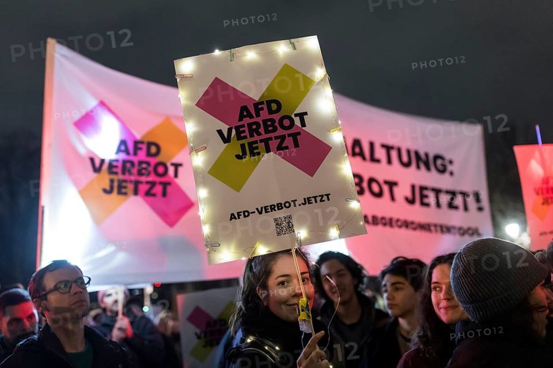 Participants with an AfD ban sign at the demonstration under the motto Sea of Lights against the shift to the right in front of the Brandenburg Tor. The demonstration is directed against the general shift to the right in Germany by the AfD and CDU, among others, and in the USA by Donald Trump and Elon Musk, among others. Berlin, 25.01.2025