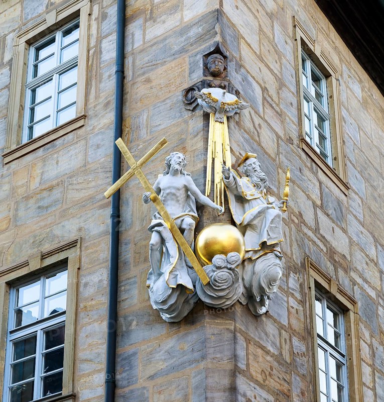 Representation of the Trinity of God with God the Father, God the Son and the Holy Spirit in the form of a dove, large sculpture on the corner of a house in the mountain town, Bamberg, Bavaria, Germany, Europe